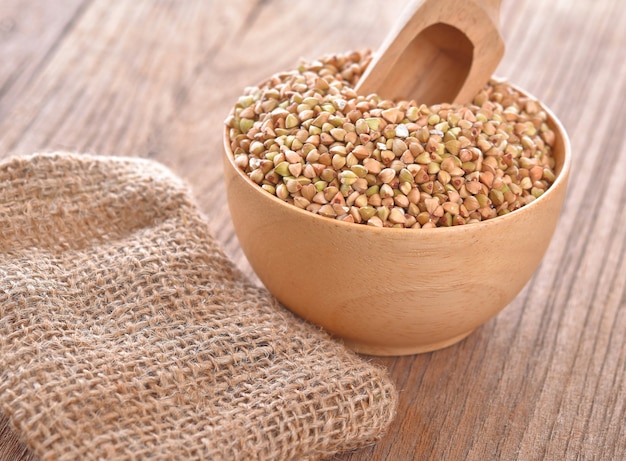 Buckwheat isolated in wooden bowl on the table