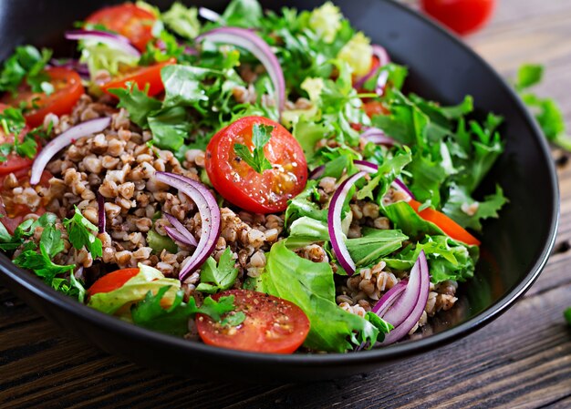 Buckwheat salad with cherry tomatoes, red onion and fresh herbs. Vegan food. Diet menu.