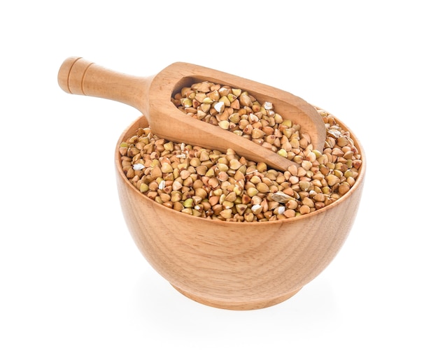 Buckwheat seeds in wood bowl on white background