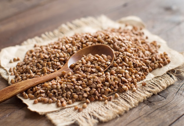 Buckwheat and a spoon on a wooden table