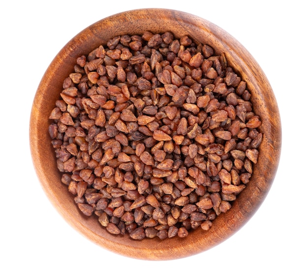 Buckwheat tea in wooden bowl isolated on white background whole roasted buckwheat grains fagopyrum