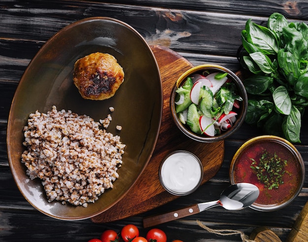 Buckwheat with cutlet borscht and salad