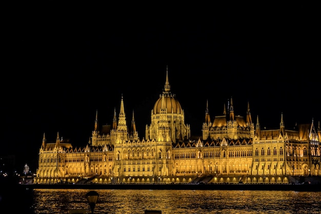 Budapest Parliament lighted in Hungary at night on the Danube river