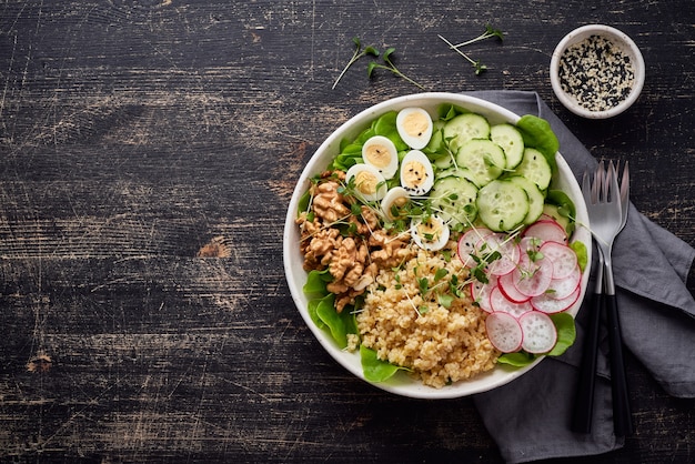 Buddha bowl, balanced food, vegetarian menu, dash diet. Dark wooden table