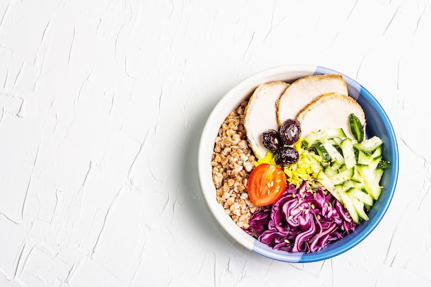 Buddha Bowl. Buckwheat, baked lean pork, red cabbage, cucumber, tomato, olives, flax seeds.