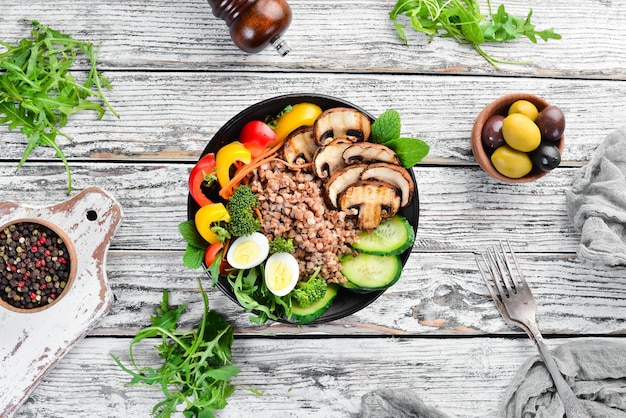 Buddha bowl Buckwheat with mushrooms eggs and vegetables Top view free space for your text