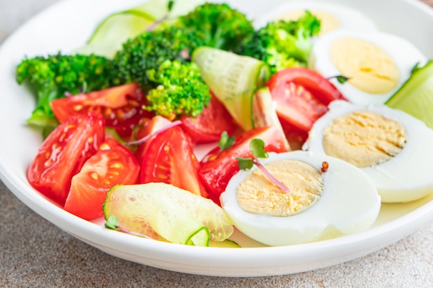 buddha bowl fresh salad boiled egg broccoli tomato cucumber vegetables meal snack on the table