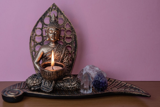 Buddha craft with a lit candle and gems