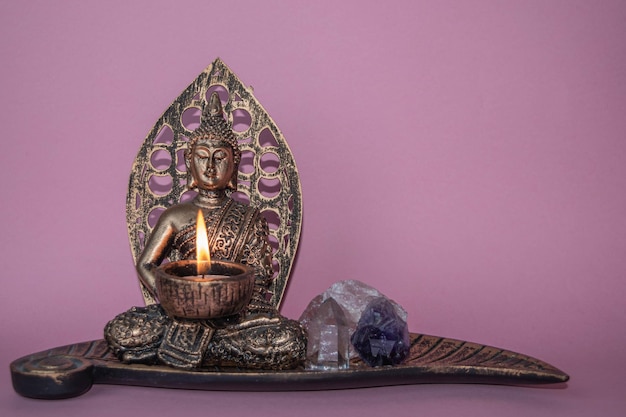 Buddha craft with a lit candle and gems