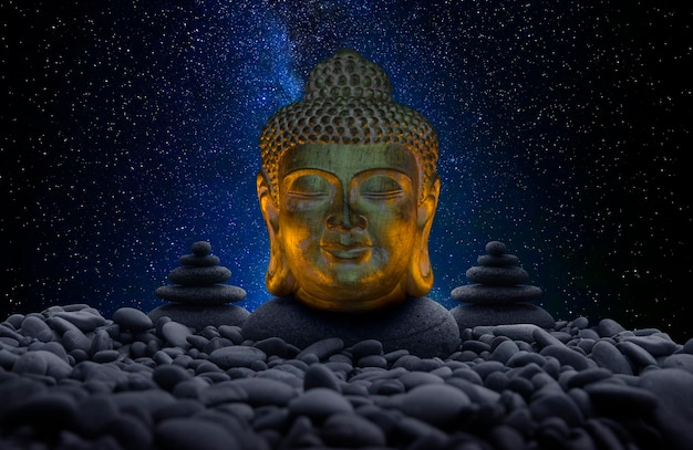 Buddha image between stones and universe background