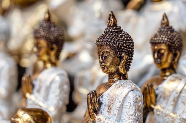 Buddha statue figures souvenir on display for sale on street market in Ubud, Bali, Indonesia. Handicrafts and souvenir shop display, close up