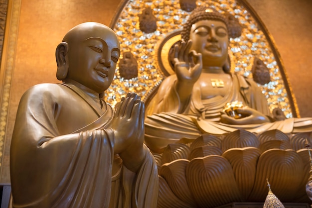 Buddha Statues in Bangkok Thailand
    
     Buddha statues made of teak, Theravada Buddhism Institute - Mahayana  (Fo Guang Shan Thaihua Temple)