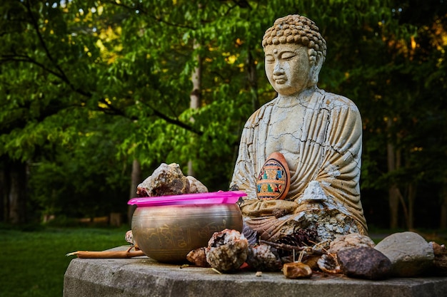 Buddhist prayer small statue with cracks and donations around