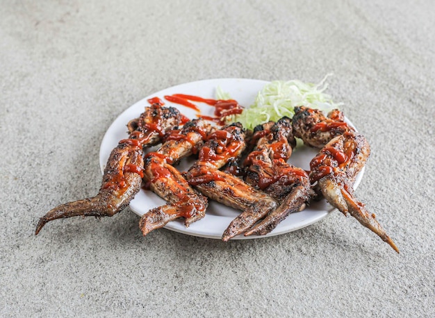 Buffalo chicken wings served in a dish isolated on grey background side view of fast food