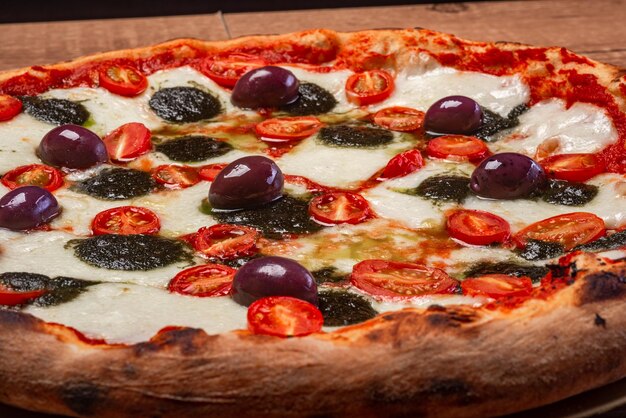 Buffalo mozzarella pizza cherry tomatoes basil pesto and black olives