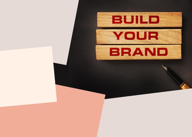 Photo build your brand written on wooden blocks with vintage styled background branding rebranding marketing concept