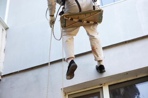 Builder climber works at height closeup