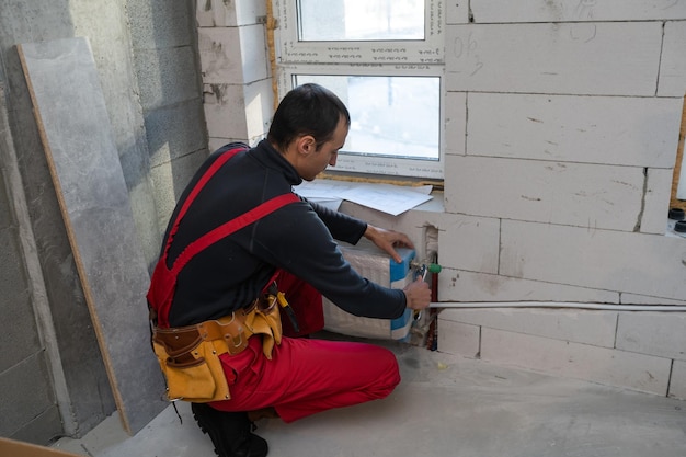 Builder handyman with construction tools. House renovation background.