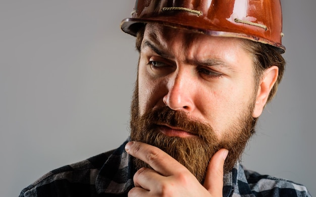 Builder in hard hat foreman or repairman in helmet mechanical worker in hardhat closeup portrait