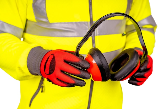 builder in ivisibility fleece and safety gloves holding ear defenders isolated with space for text