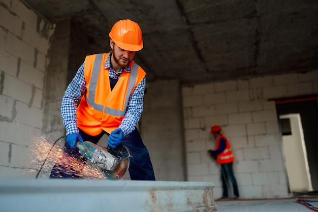 Builder worker with grinder machine cutting metal