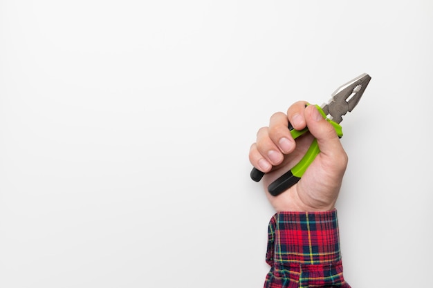 Photo builders male hand holding pliers on white mockup background close-up