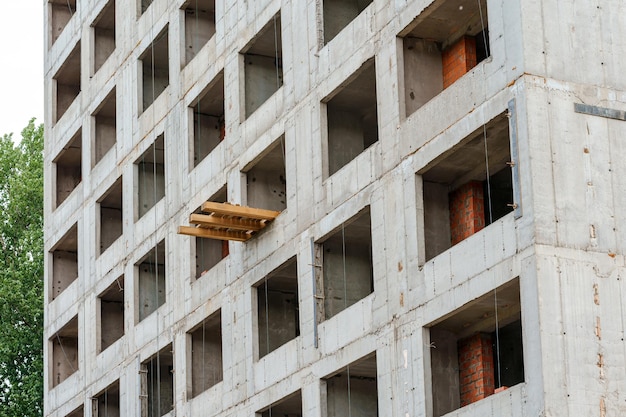 A building being constructed with a brick wall and a window with the word building on it.