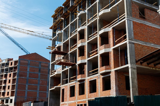 Building crane and house under construction