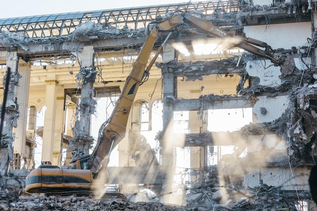 Building demolition excavator with long mechanical arm Destruction of a house reconstruction