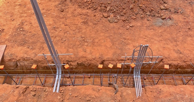 Building a house foundation with steel in a trench on construction site