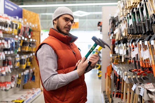 Building materials stores a man chooses a new hammer