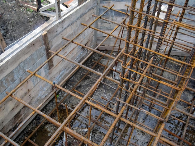 Photo building process installing rebar grids for concrete foundation detailed view