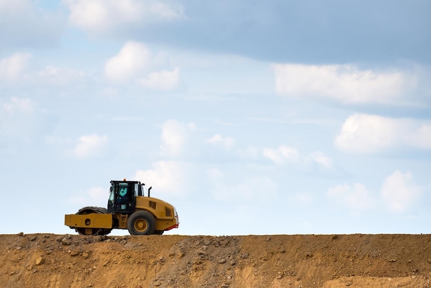 Building a road with varied machinery against the sky Copy Space