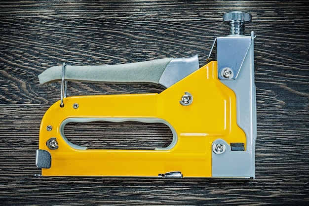 Photo building stapler gun on wooden board