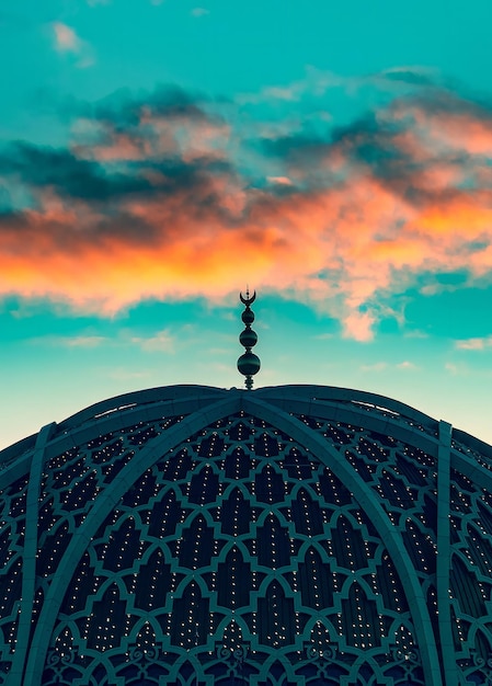 A building with a blue dome and a moon on the top.