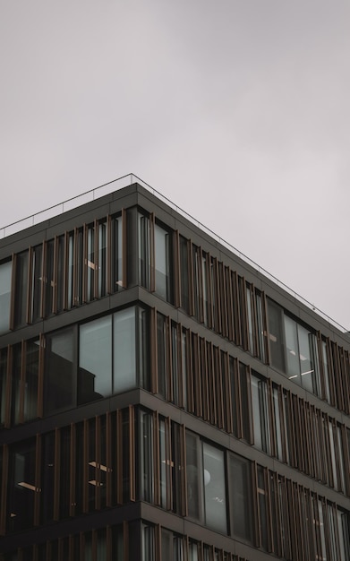 A building with a brown facade and a white sky in the background.