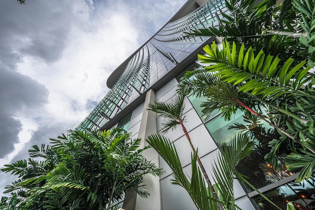 A building with green plants and trees in front of it