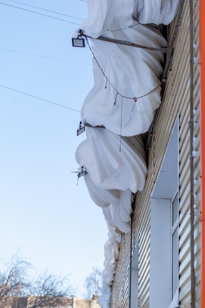 A building with a red wall and a white sheet covering it.