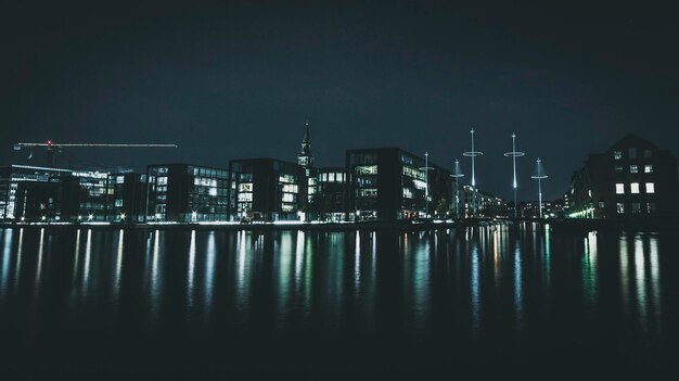 Buildings by the water at night