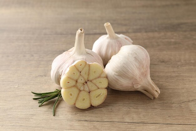 Bulbs of garlic on wooden background close up