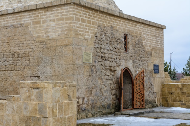 Bulgarian settlement. Limestone Khan's tomb on a cloudy spring day in Bolgar, Tatarstan, Russia. Inscriptions: "Khan's tomb of the 14th century and its history"