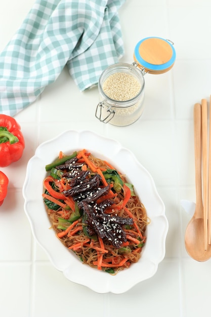 Bulgogi Japchae Stir Fried Korean Vermicelli Noodles with Vegetables and Beef Topped with White Sesame Seed