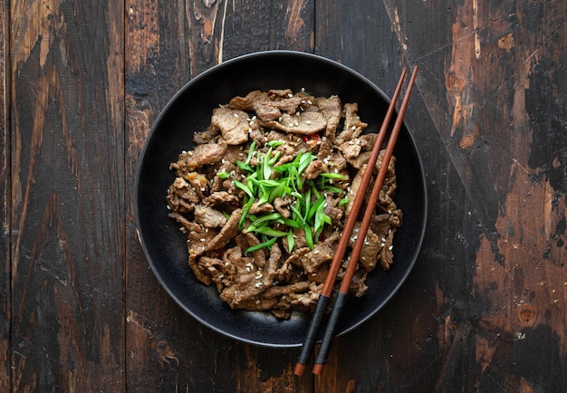 Bulgogi with rice on wooden background korean food top view copy space