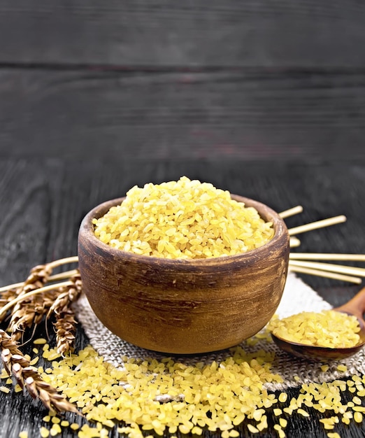 Bulgur in bowl on wooden board