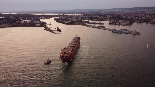 Bulk carrier cargo ship enters the port for unloading in the evening