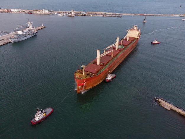 Bulk carrier cargo ship enters the port for unloading in the evening