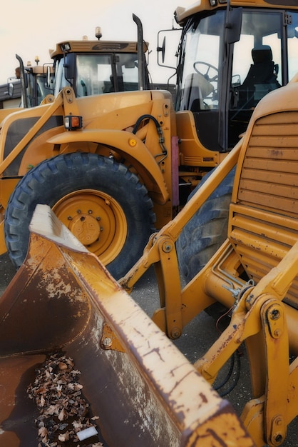 Bulldozer in action at construction site An industrial excavator on an open road section loading heavy concrete rocks and dirt Motorized machine equipped for pushing material soil sand or rubble