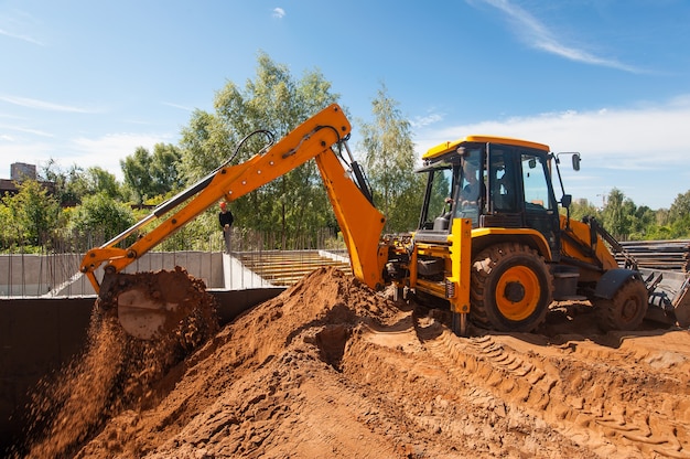 A bulldozer digs a trench on a construction site Earthworks