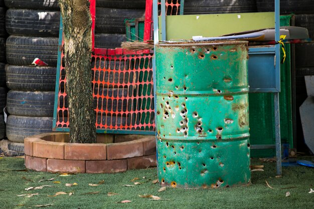 Bullet holes on metal oil barrels