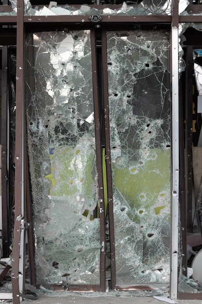 Bullet and shrapnel holes in the entrance door to the supermarket